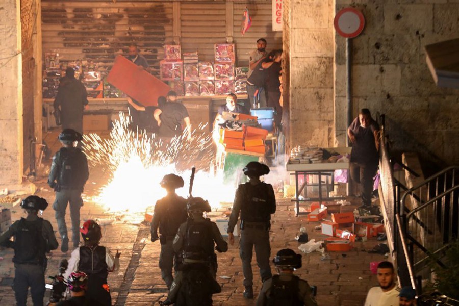 Palestinians react as Israeli police fire a stun grenade during clashes at Damascus Gate on Laylat al-Qadr during the holy month of Ramadan, in Jerusalem's Old City on May 9, 2021 — Reuters photo