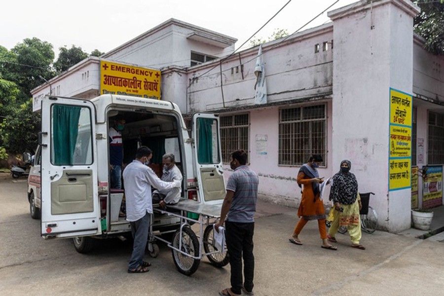 Relatives help Jagdish Singh, 57, out of an ambulance outside a government-run hospital to receive treatment, amidst the coronavirus disease (COVID-19) pandemic, in Bijnor district, Uttar Pradesh, India, May 11, 2021. REUTERS