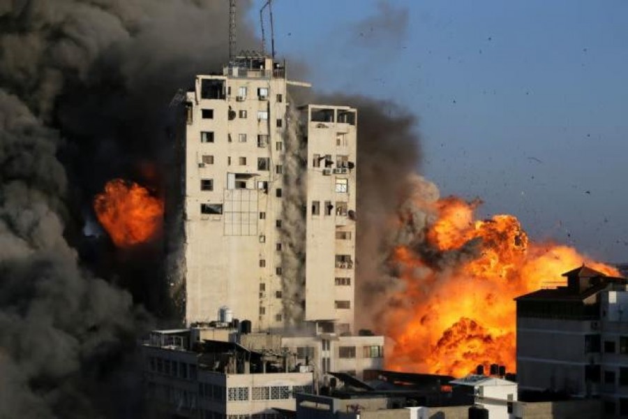 Smoke and flames rise from a tower building as it is destroyed by Israeli air strikes amid a flare-up of Israeli-Palestinian violence, in Gaza City on May 12, 2021 — Reuters photo