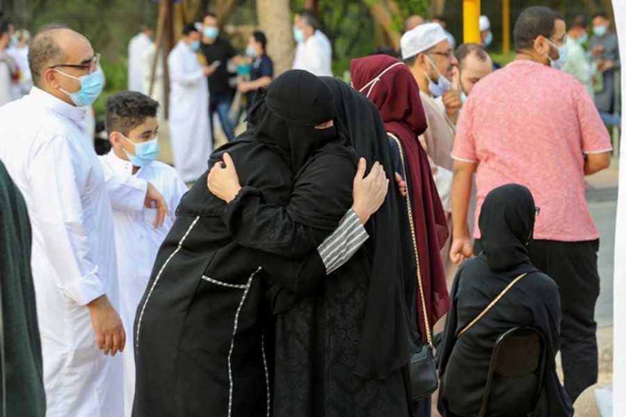 Saudi women greet each other after performing Eid prayers on the first day of Eid-ul-Fitr, amid the coronavirus disease (COVID-19) pandemic, outside the King Abdulaziz Mosque, in Riyadh, Saudi Arabia, May 13, 2021. REUTERS   