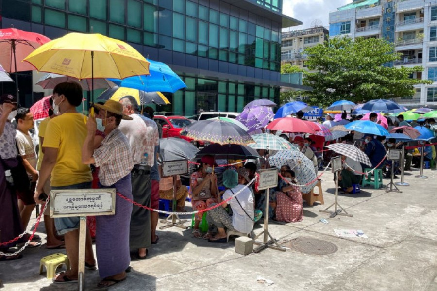 People line up outside a bank to withdraw cash, in Yangon, Myanmar on May 13, 2021 — Reuters/Files