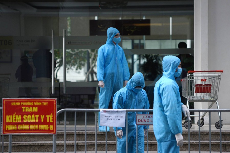 Medical workers in protective suits stand outside a quarantined building amid the coronavirus disease (Covid-19) outbreak in Hanoi, Vietnam on January 29, 2021 — Reuters/Files