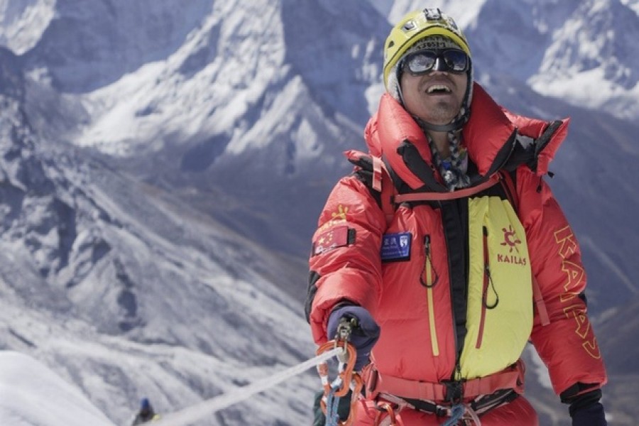 Chinese mountaineer Zhang Hong, the first blind Asian person to scale Mount Everest, smiles after reaching the top of a difficult section of the climb. Photo: InHope Pictures