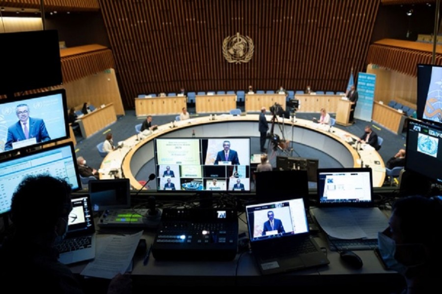 World Health Organization (WHO) Director General Tedros Adhanom Ghebreyesus is seen on screens as he attends the World Health Assembly (WHA) amid the coronavirus disease (COVID-19) pandemic in Geneva, Switzerland, May 24, 2021. Christopher Black/World Health Organization/Handout via REUTERS