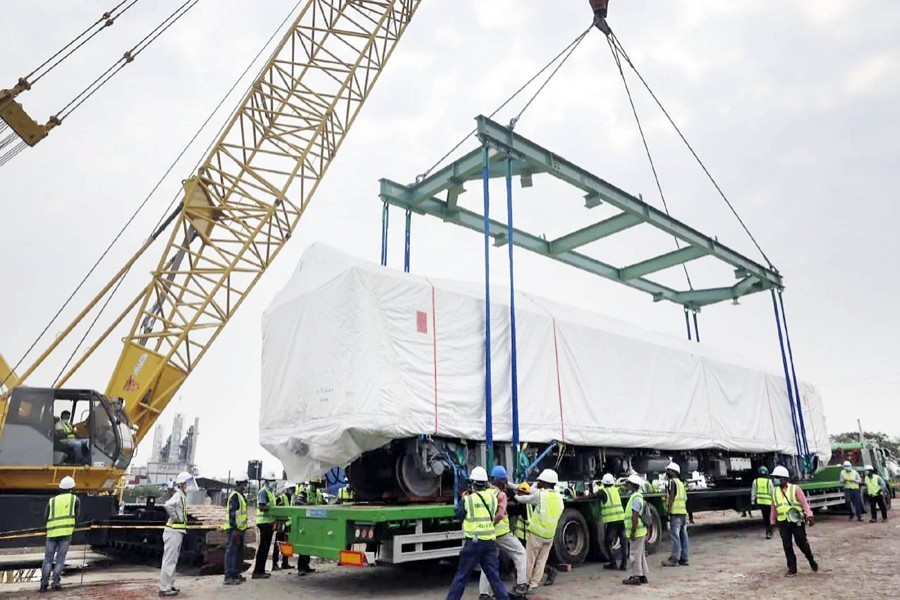 One of the Metro Rail coaches is being lifted into a lorry with the help of a crane for transportation to Dhaka Mass Transit Company's depot at Diabari in Uttara, Dhaka — Focus Bangla/Files