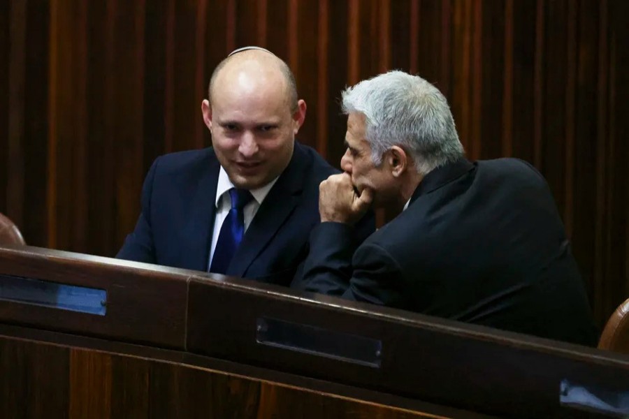 Yamina party leader Naftali Bennett smiles as he speaks to Yesh Atid party leader Yair Lapid, during a special session of the Knesset whereby Israeli lawmakers elect a new president, at the plenum in the Knesset, Israel's parliament, in Jerusalem on June 2, 2021 — Reuters photo