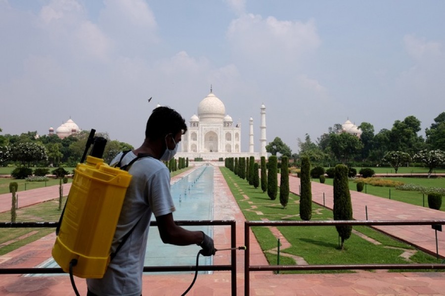 A man sanitizes railings in the premises of Taj Mahal after authorities reopened the monument to visitors, amidst the coronavirus disease (COVID-19) outbreak, in Agra, India, Sept 21, 2020. REUTERS/FILE