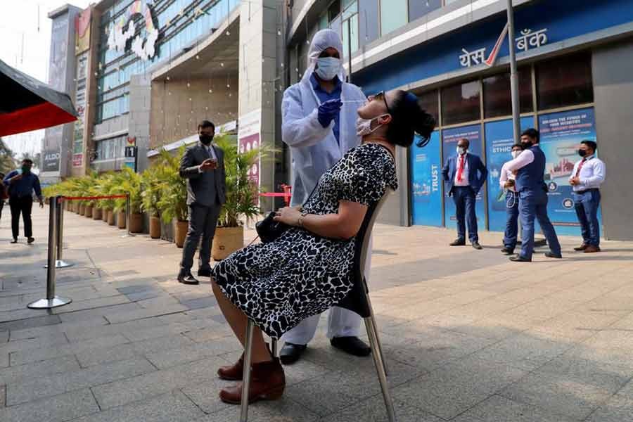 An Indian healthcare worker collecting a swab sample from a woman during a rapid antigen testing campaign for coronavirus disease (COVID-19), outside a shopping mall in Mumbai, on March 22 this year -Reuters file photo