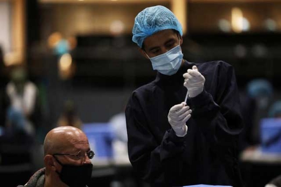 A health worker fills a syringe with a dose of the Pfizer-BioNTech coronavirus disease (Covid-19) vaccine at Movistar Arena in Bogota, Colombia, June 16, 2021 — Reuters