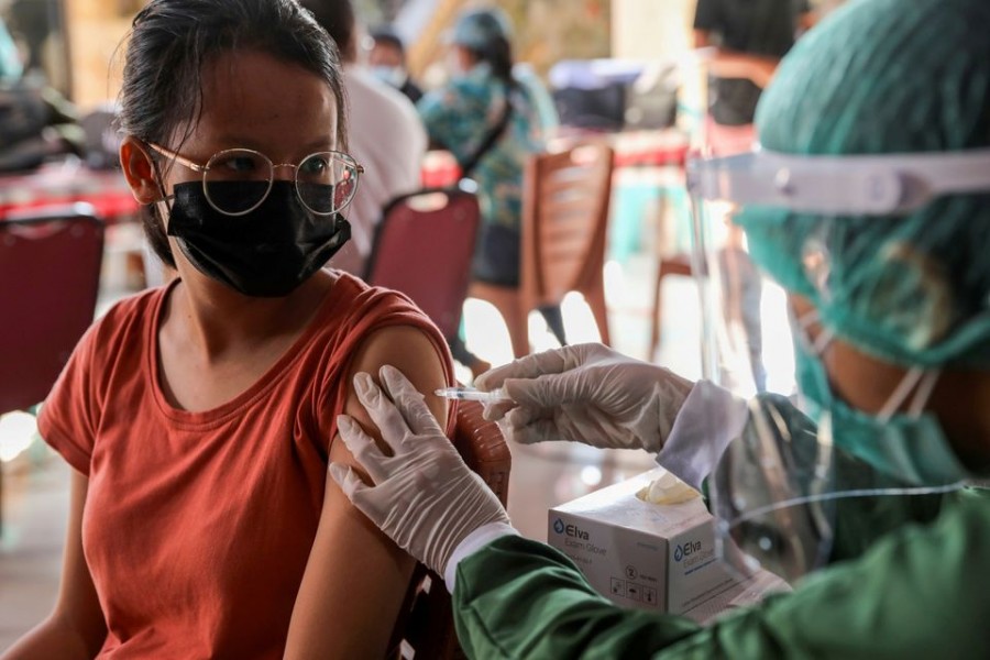 A woman receives a dose of AstraZeneca Covid-19 vaccine during a mass vaccination programme for Green Zone Tourism in Sanur, Bali, Indonesia on March 23, 2021 — Reuters/Files