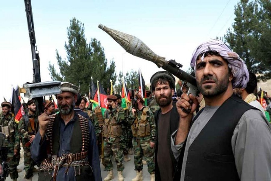 Armed men attend a gathering to announce their support for Afghan security forces and that they are ready to fight against the Taliban, on the outskirts of Kabul, Afghanistan June 23, 2021. REUTERS/Stringer