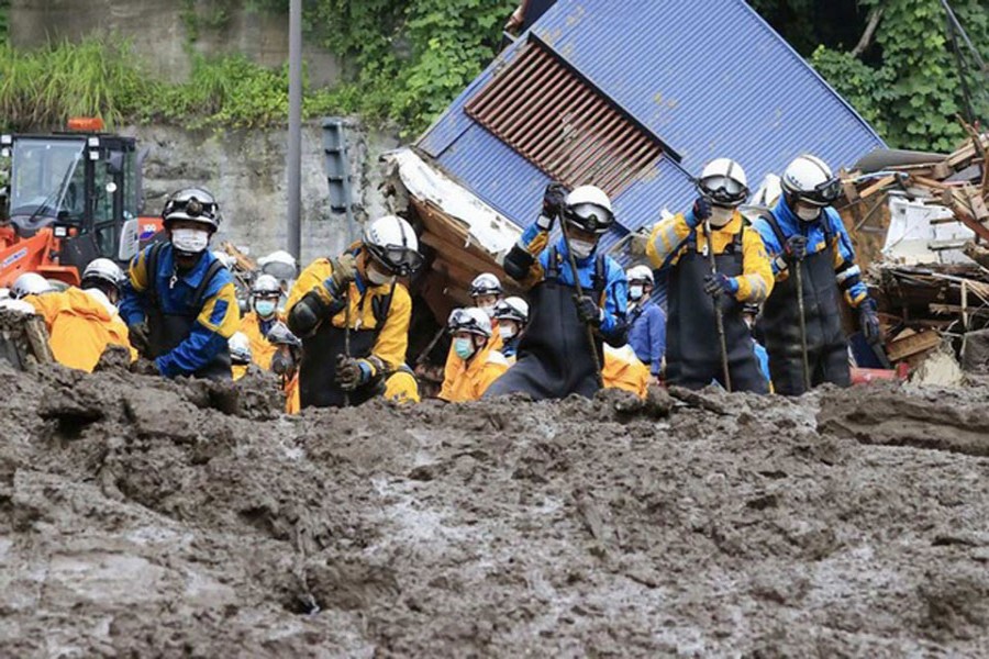 Police officers conduct a rescue and search operation at the site of a mudslide caused by heavy rain at Izusan district in Atami, Japan July 5, 2021, in this photo taken by Kyodo. Kyodo/via REUTERS