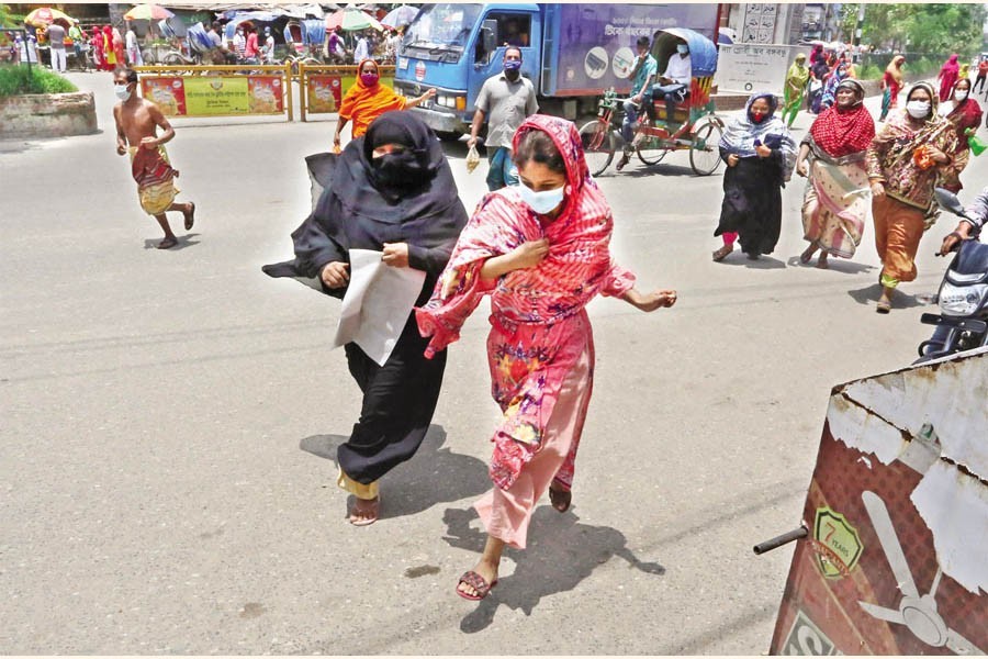 As the news of a TCB truck's arrival gets around, women rush towards the sales point to buy essential items at subsidised prices. The photo was taken in Mohammadpur bus stand area in the city on Thursday — FE photo by KAZ Sumon