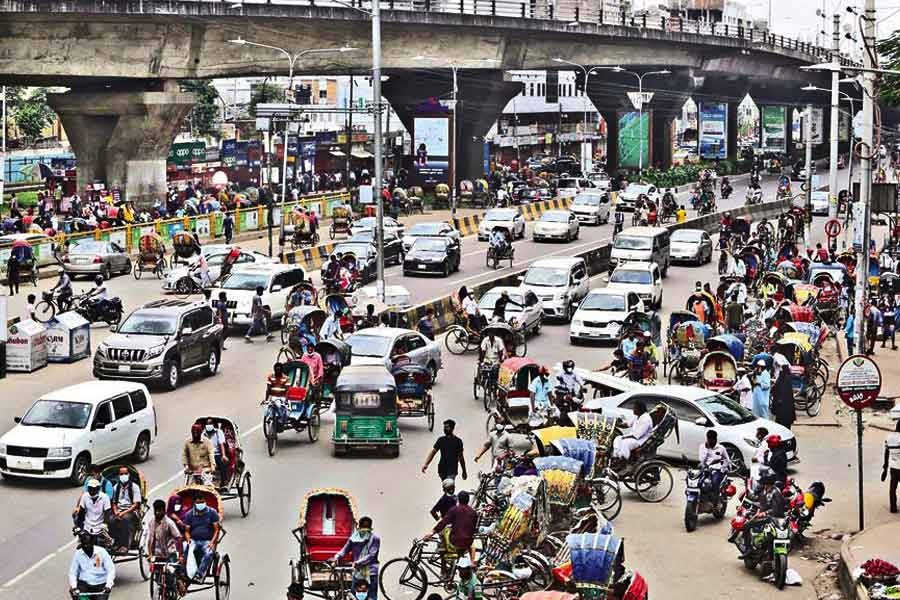 City streets saw an increase in the number of people and vehicles, mostly private ones, during the ongoing lockdown on Tuesday. The photo was taken at the Mohakhali intersection —FE photo by KAZ Sumon