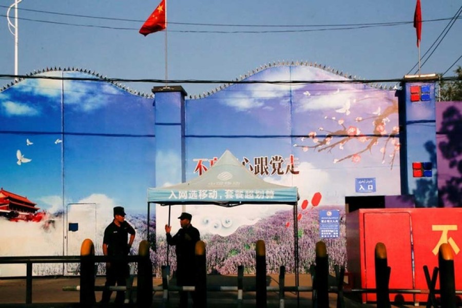 Security guards stand at the gates of what is officially known as a vocational skills education center in Huocheng County in Xinjiang Uighur Autonomous Region, China September 3, 2018 - Reuters photo