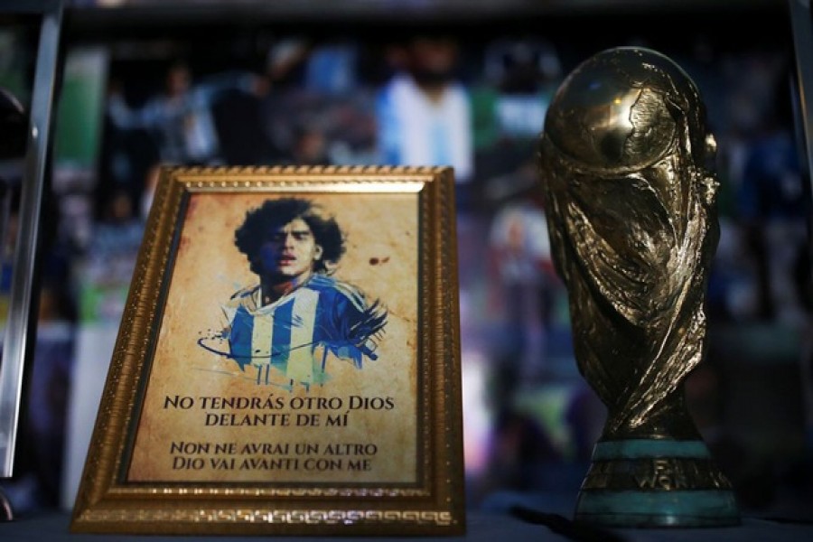 A picture of Diego Maradona and a replica of the World Cup trophy are pictured on an altar at the first Mexico's church in memory of football legend Diego Armando Maradona in San Andres Cholula, in Puebla state, Mexico July 14, 2021. REUTERS