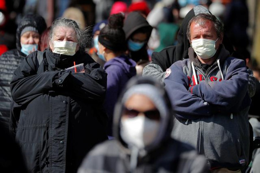 People wait in a line around the block for a pop-up food pantry amid the coronavirus disease (Covid-19) outbreak in Chelsea, Massachusetts, US on April 17, 2020 — Reuters/Files