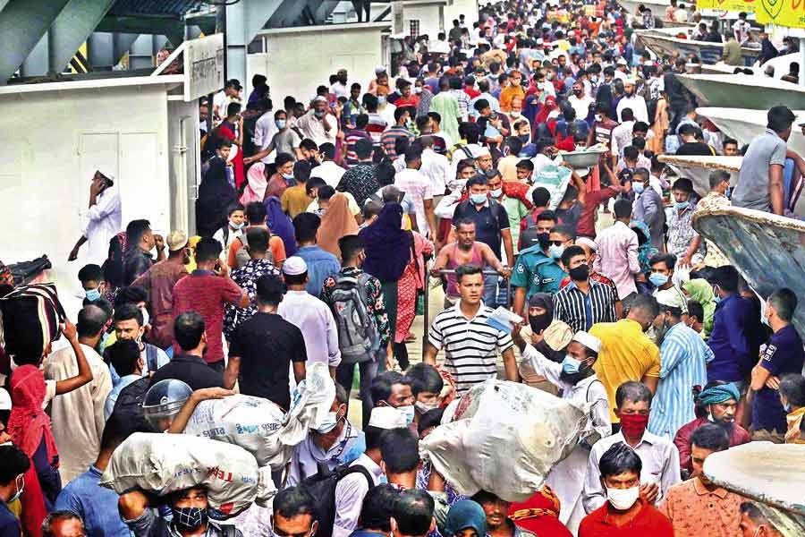 Amid the worsening Covid-19 situation in the country, passengers gather at the Shadarghat launch terminal in Dhaka last Friday without maintaining any health guidelines.  — FE photo by KAZ Sumon