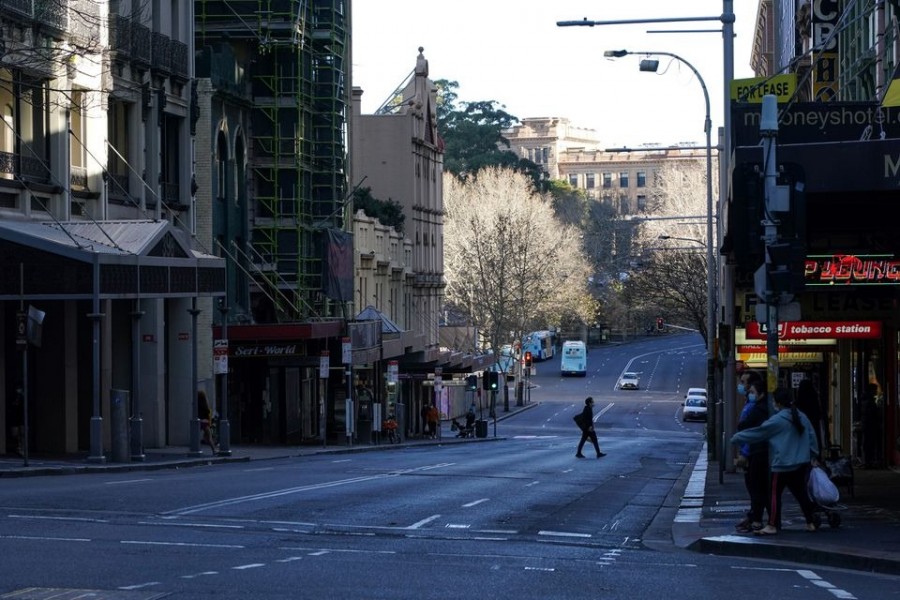 A pedestrian crosses an almost empty street in the City Centre during a lockdown to curb the spread of the coronavirus disease (Covid-19) outbreak in Sydney, Australia on July 21, 2021 — Reuters photo