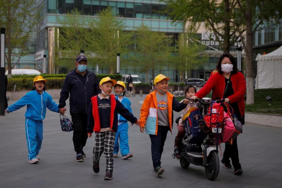 People pick up children from a school in Beijing, China on April 6, 2021 — Reuters/Files