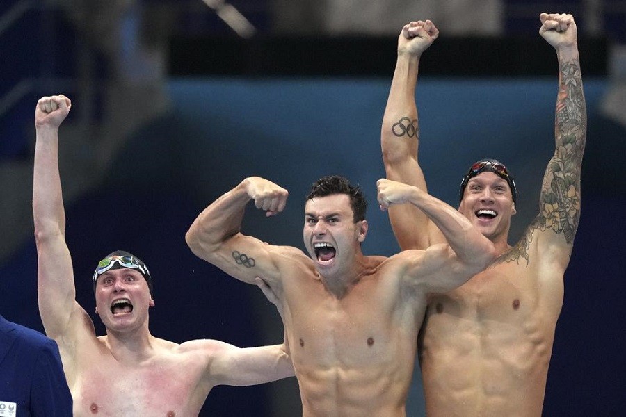 United States men's 4x100m freestyle relay team Bowen Beck, Blake Pieroni, and Caeleb Dressel celebrate after winning the gold medal at the 2020 Summer Olympics, Monday, July 26, 2021, in Tokyo, Japan — AP Photo/Matthias Schrader