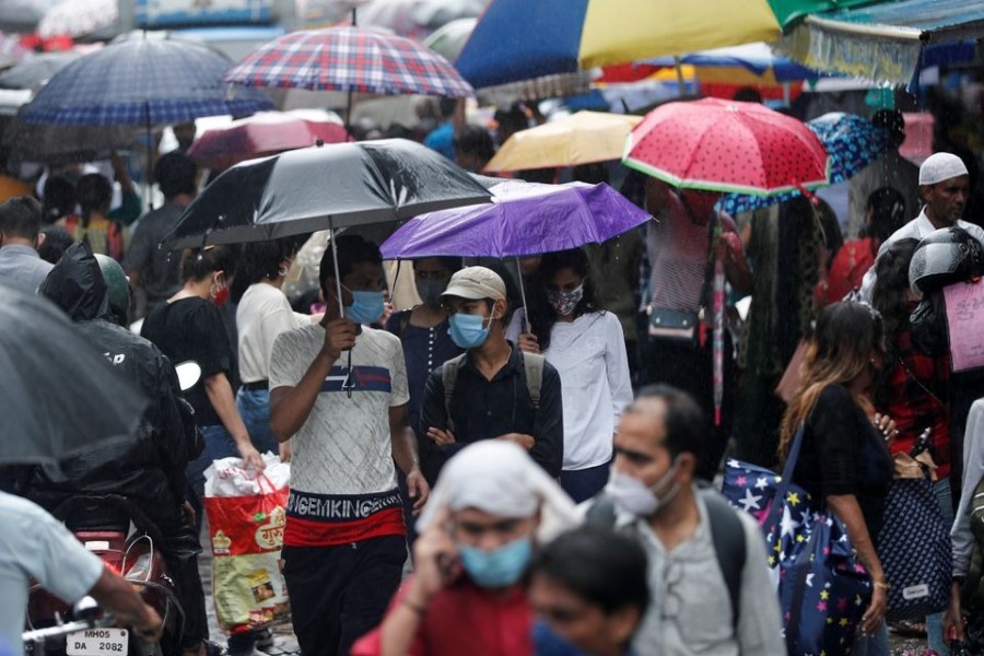 People walk through a crowded market on a rainy day amidst the spread of the coronavirus disease (Covid-19) in Mumbai, India on July 14, 2021 — Reuters/Files