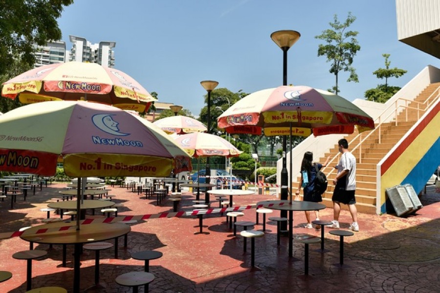 The seating area at a food centre is cordoned off to restrict dining-in as part of the latest measures to curb the coronavirus disease (COVID-19) outbreak in Singapore July 23, 2021. REUTERS