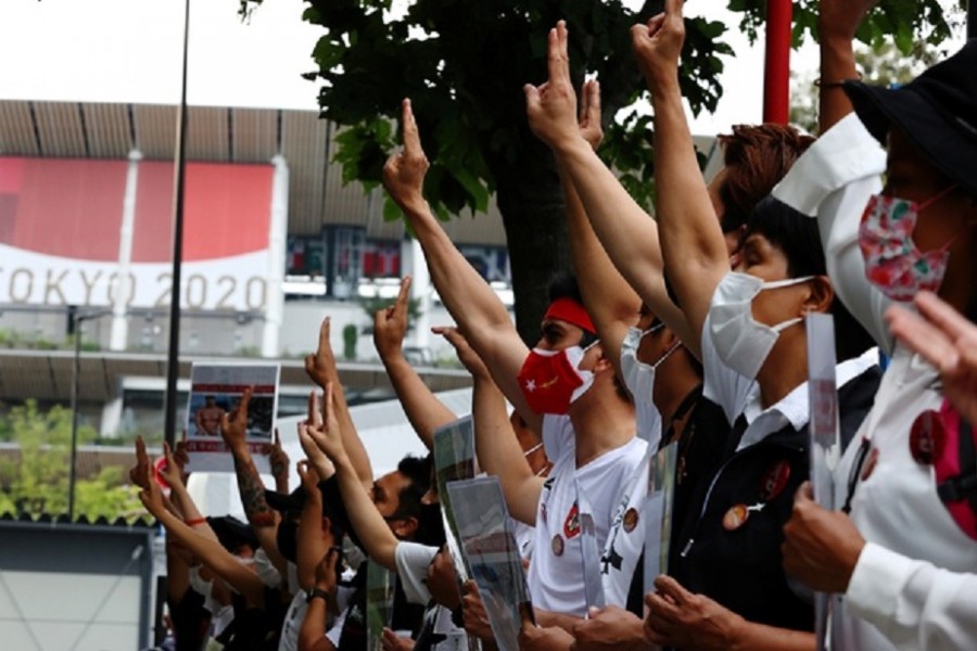 Protesters show three-finger salute during a rally of Myanmar protesters residing in Japan, outside the National Stadium, the main venue of the Tokyo 2020 Olympic Games, in Tokyo, Japan, Jul 26, 2021. REUTERS