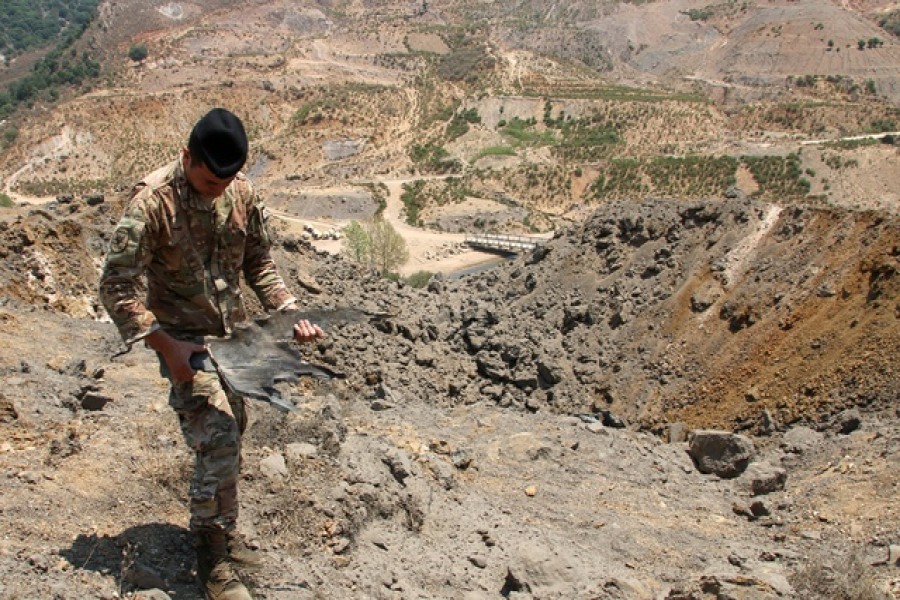 A Lebanese army member holds the remains of Israeli ammunition as he stands near the damage in the aftermath of Israeli air strikes in Marjayoun, near the border with Israel, Lebanon Aug 5, 2021 — Reuters