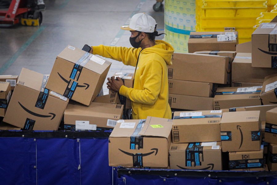 An employee scans packages at Amazon's JFK8 distribution center in Staten Island, New York, US on November 25, 2020 — Reuters/Files