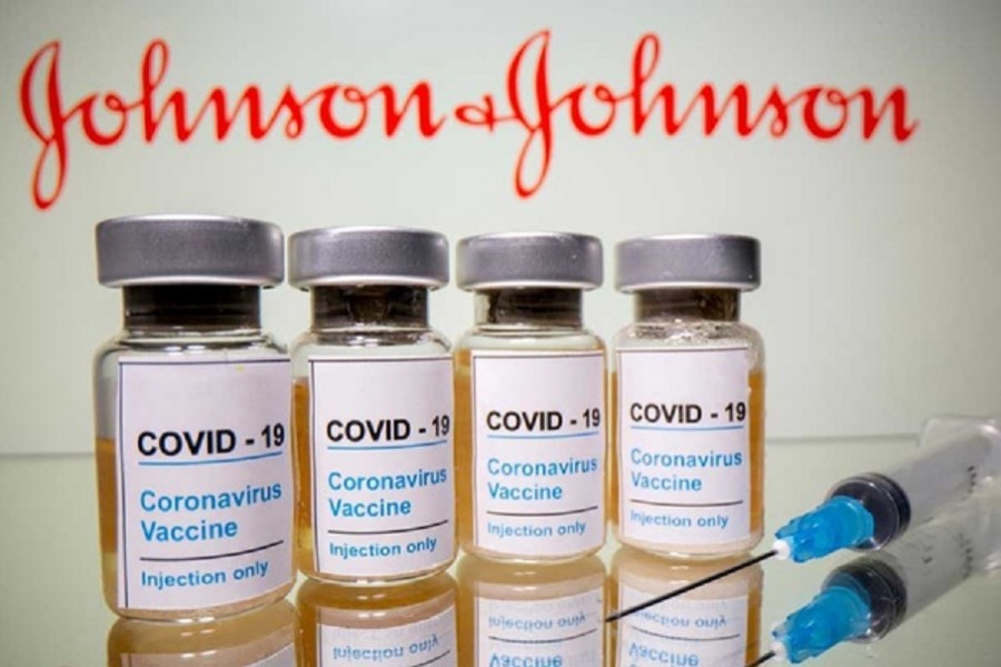 Vials with a sticker reading, "COVID-19 / Coronavirus vaccine / Injection only" and a medical syringe are seen in front of a displayed Johnson & Johnson logo in this illustration taken October 31, 2020. REUTERS