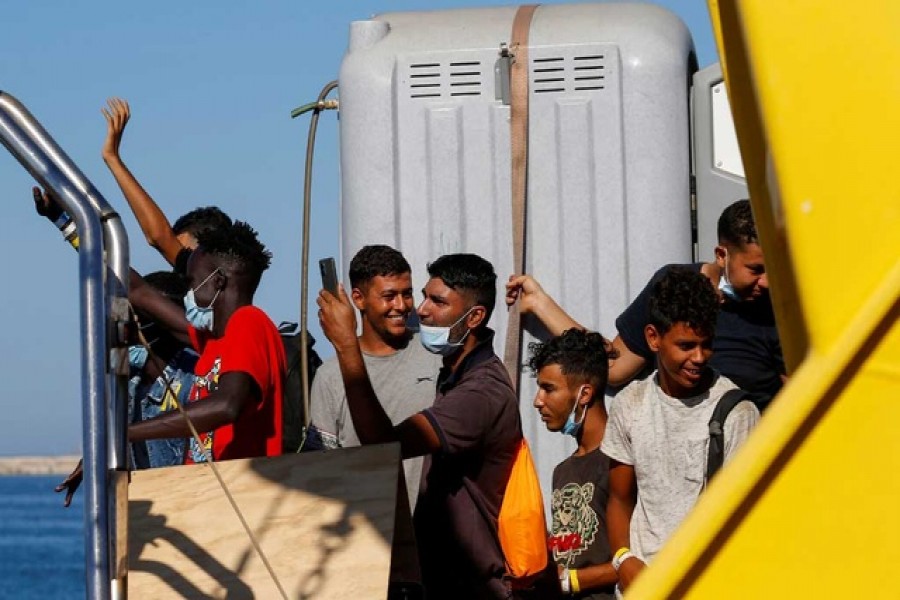 Migrants wait to disembark from the German NGO migrant rescue ship Sea-Watch 3 as it arrives with 257 rescued migrants on board in Trapani on the island of Sicily, Italy August 7, 2021. Reuters