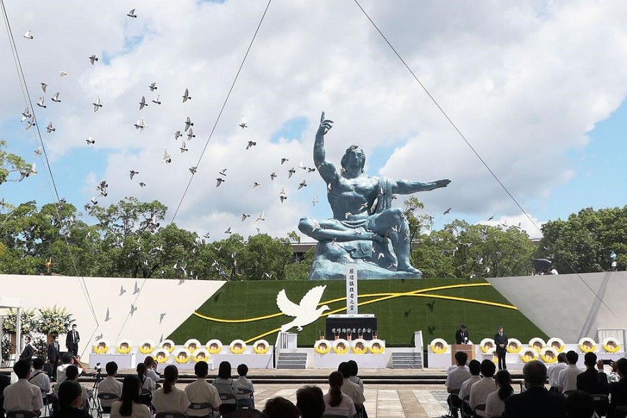 Doves fly over the Statue of Peace during a ceremony at Nagasaki Peace Park in Nagasaki, southern Japan Monday, Aug 9, 2021—Kyodo News via AP