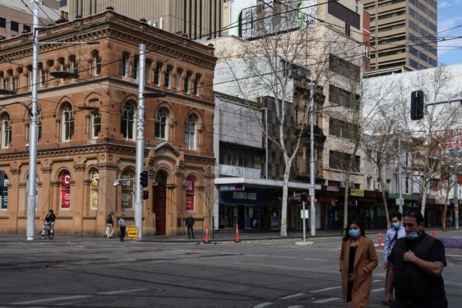 Pedestrians wearing protective face masks walk through the city centre during a lockdown to curb the spread of a coronavirus disease (Covid-19) outbreak in Sydney, Australia on August 9, 2021 — Reuters photo