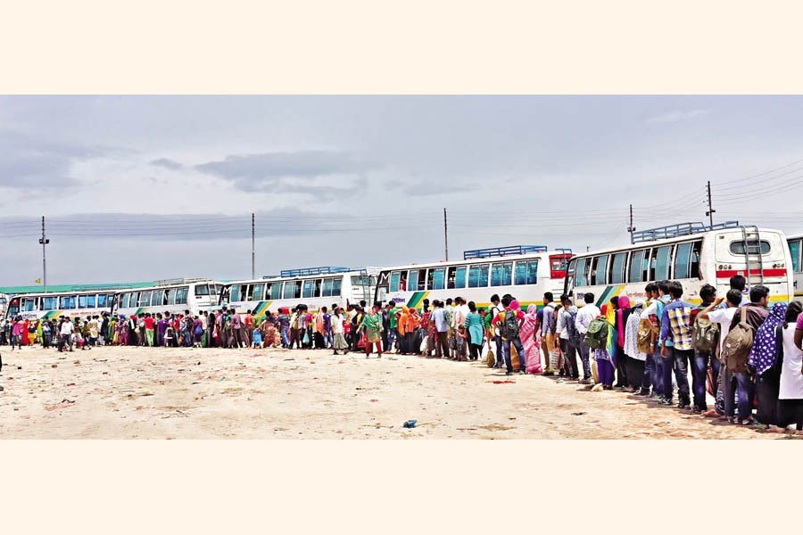 After landing at Shimulia ferry station, Dhaka-bound passengers queued up to board buses to the capital on Thursday. After Covid curbs are eased, the rush of people has increased significantly — Focus Bangla