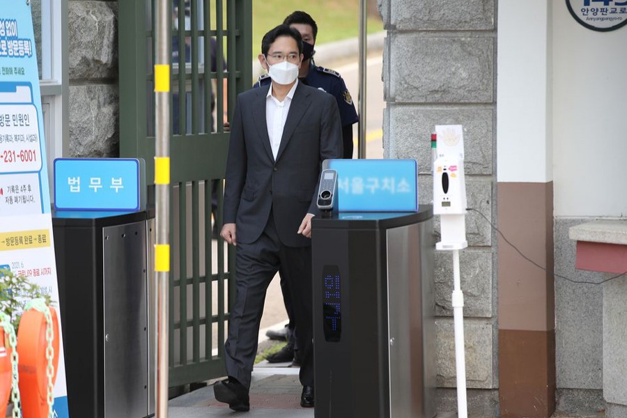 Samsung Electronics vice chairman Jay Y Lee walks as he is released on parole from Seoul Detention Center in Uiwang, South Korea on August 13, 2021 — Yonhap via REUTERS