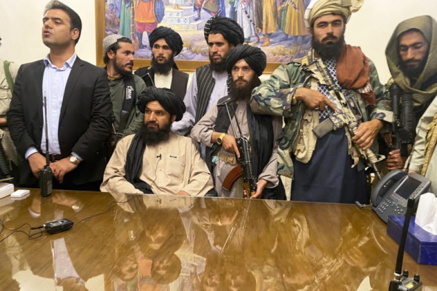 Taliban fighters take control of Afghan presidential palace after the Afghan President Ashraf Ghani fled the country in Kabul on Aug. 15, 2021. (Zabi Karimi / AP)