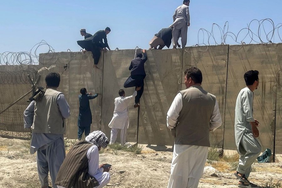 Men try to get inside Hamid Karzai International Airport in Kabul, Afghanistan on August 16, 2021 — Reuters photo