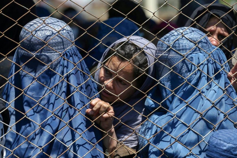 Afghan women wait to receive free wheat donated by the Afghan government during a quarantine, amid concerns about the coronavirus disease (Covid-19) in Kabul, Afghanistan on April 21, 2020 — Reuters photo