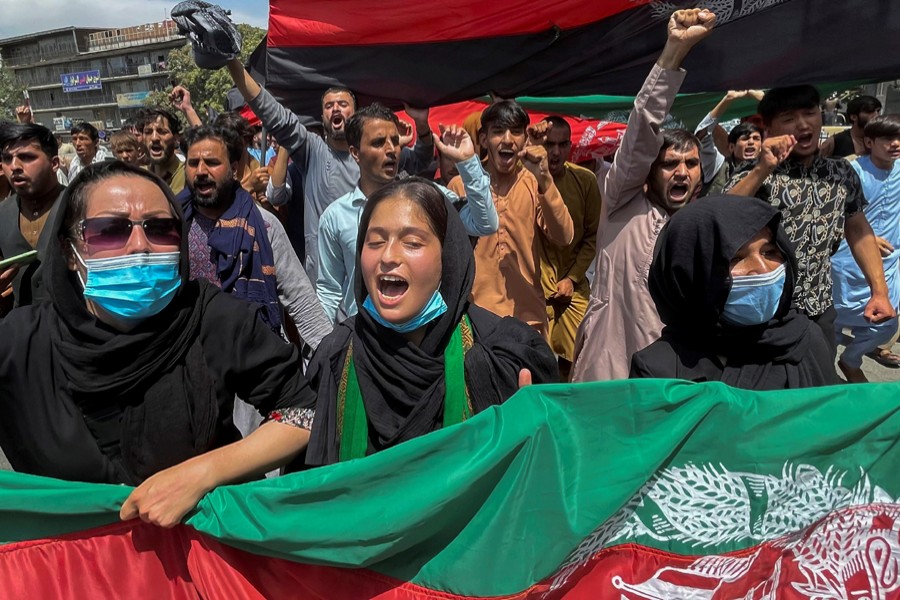 People carry the national flag at a protest held during the Afghan Independence Day in Kabul, August 19, 2021 — Reuters photo