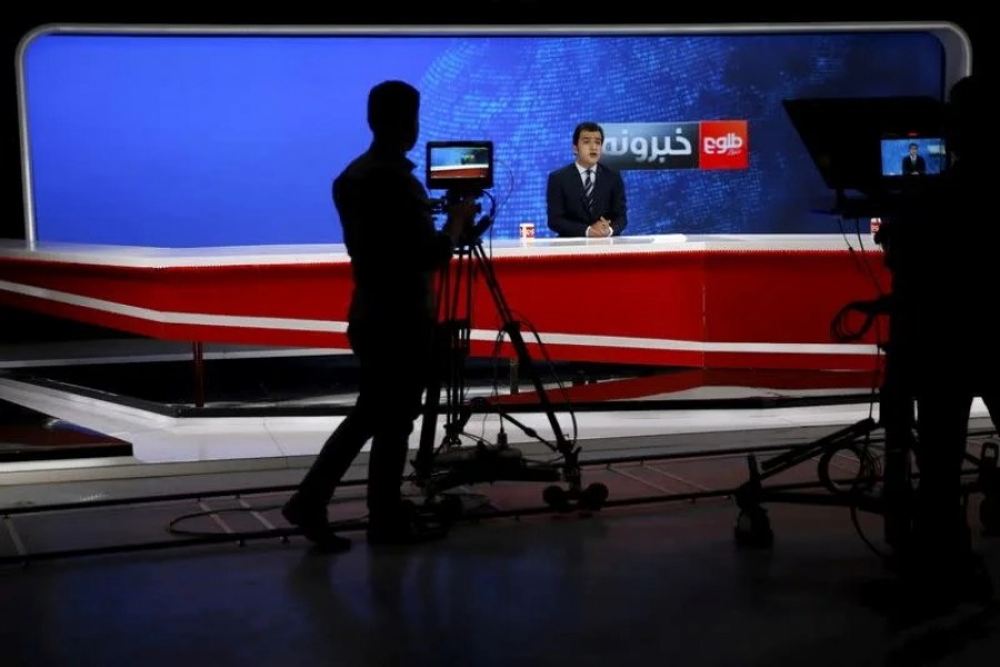 Cameraman films a news anchor at Tolo News studio, in Kabul, Afghanistan