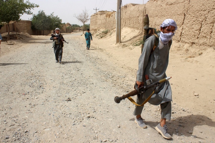 Afghan men inspect the site of a car bomb attack in Kandahar province, Afghanistan, July 6, 2021 — Reuters