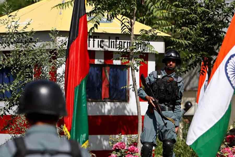 Afghan policemen standing guard next to Indian and Afghan national flags, at a check point in Kabul city on May 12 this year -Reuters file photo