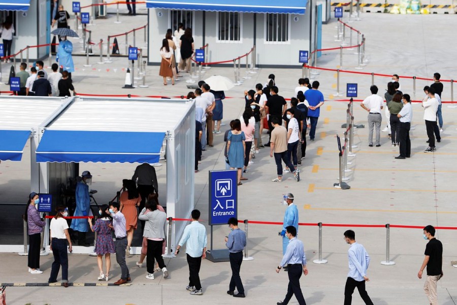 Staff members of Shanghai Pudong International Airport line up at a nucleic acid testing site to test for the coronavirus disease (COVID-19) in Shanghai, China August 20, 2021. cnsphoto via REUTERS