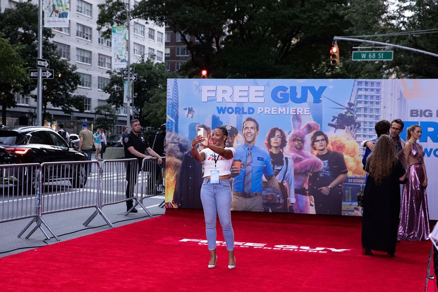 A guest takes a selfie on the red carpet at the premiere for the film ‘Free Guy’ in New York City, New York, U.S., August 3, 2021. Reuters