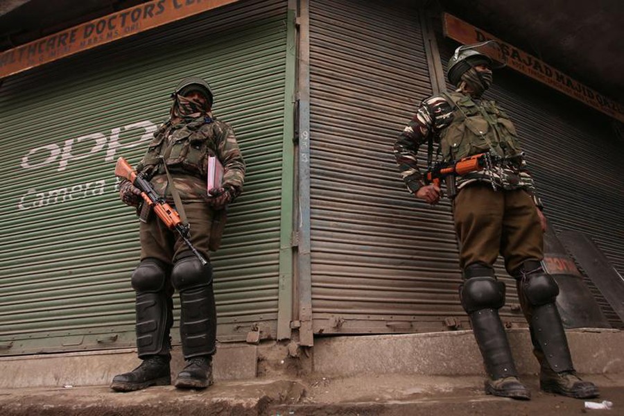 Indian Central Reserve Police Force (CRPF) personnel stand guard in front of closed shops in Srinagar on February 25, 2019 — Reuters/Files