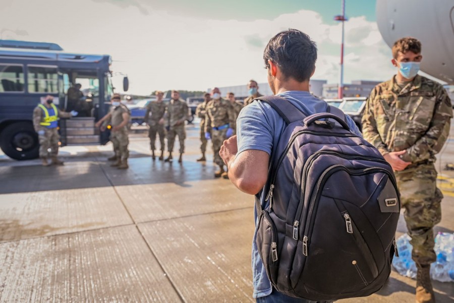 An evacuee from Afghanistan walks towards a transportation bus after landing at Ramstein Air Base, Germany, August 22, 2021. US Air Force/Senior Airman Jan K. Valle/Handout via REUTERS