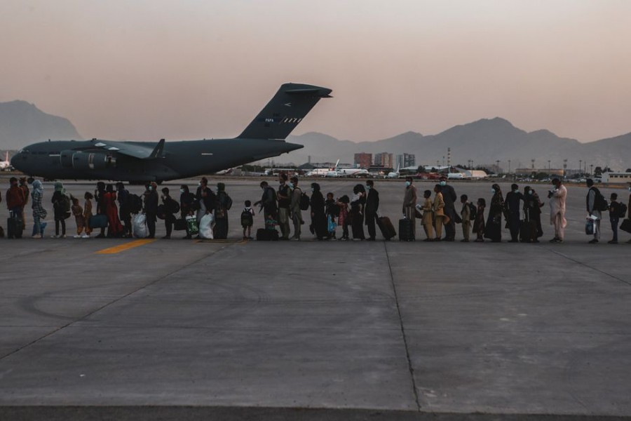 Evacuees wait to board a Boeing C-17 Globemaster III during an evacuation at Hamid Karzai International Airport in Kabul, Afghanistan on August 23, 2021 — US Marine Corps Handout via REUTERS