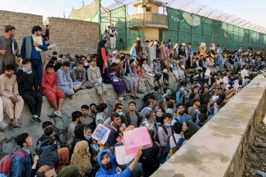 Crowds of people wait outside the airport in Kabul, Afghanistan August 25, 2021 in this picture obtained from social media. Twitter/DAVID_MARTINON via REUTERS