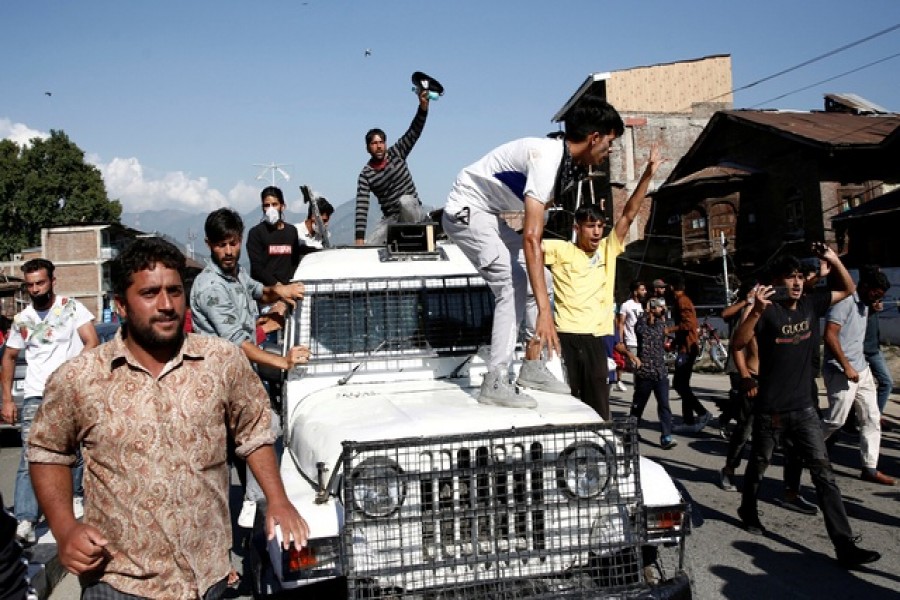 Kashmiri Shi'ite Muslim mourners shout slogans atop a police vehicle during a Muharram procession ahead of Ashura in Srinagar Aug 17, 2021. REUTERS/Danish Ismail/File